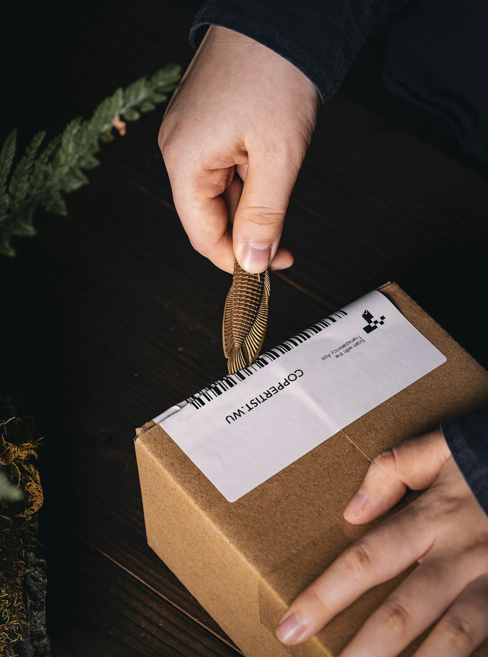 A maker packing an order to ship