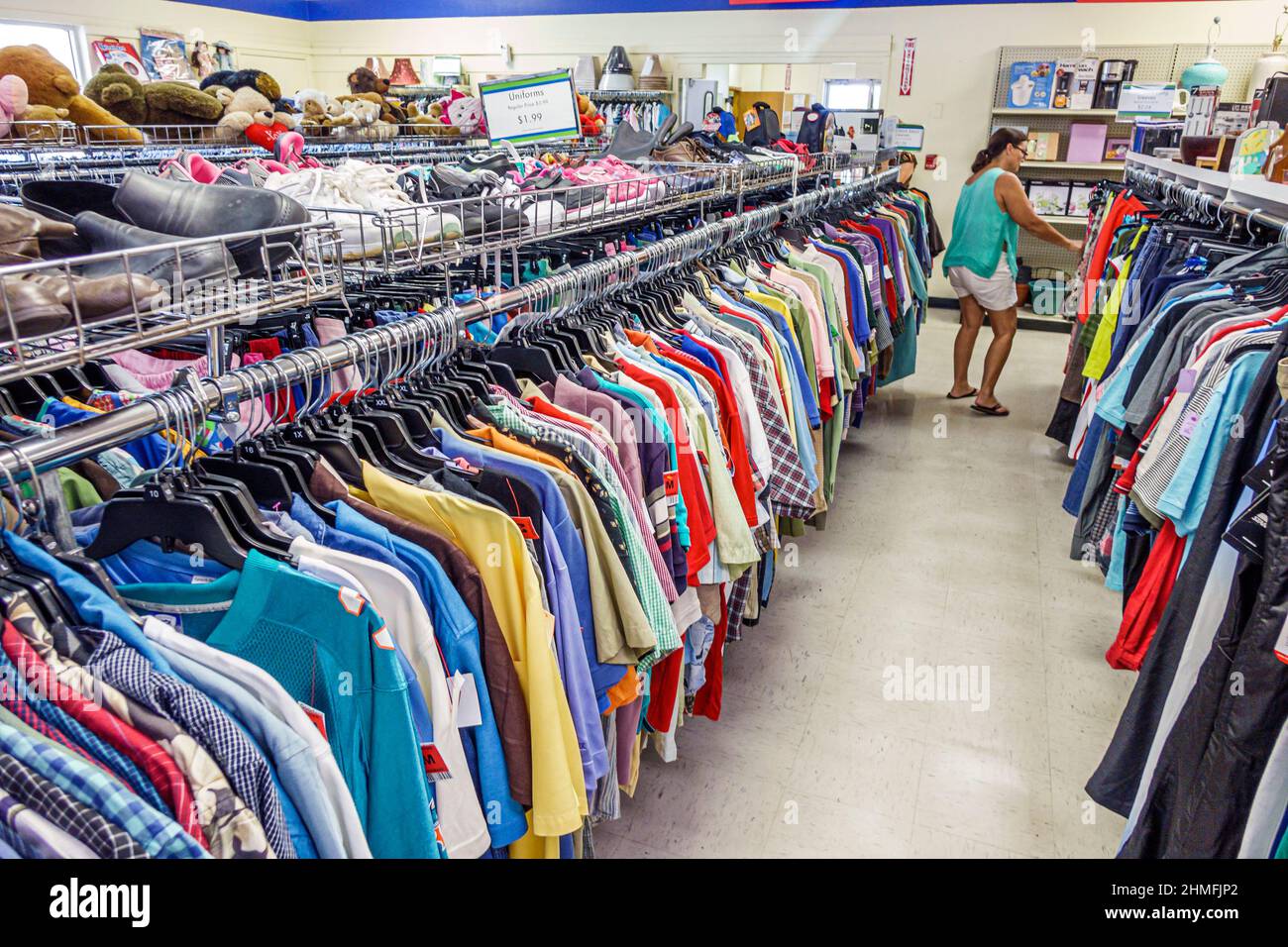 Rows of clothing racks in a thrift store aisle