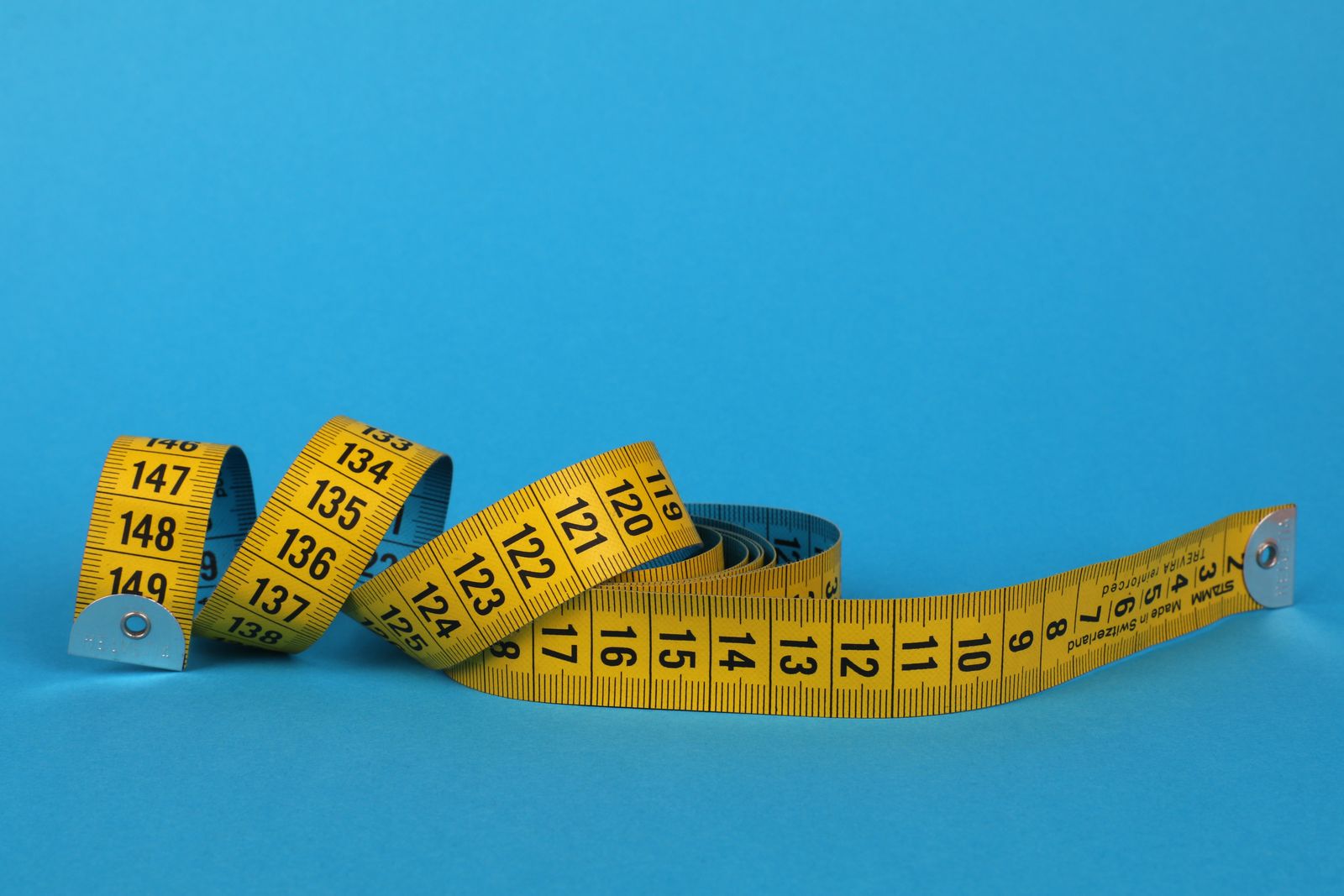 A soft tape measure coiled on a table
