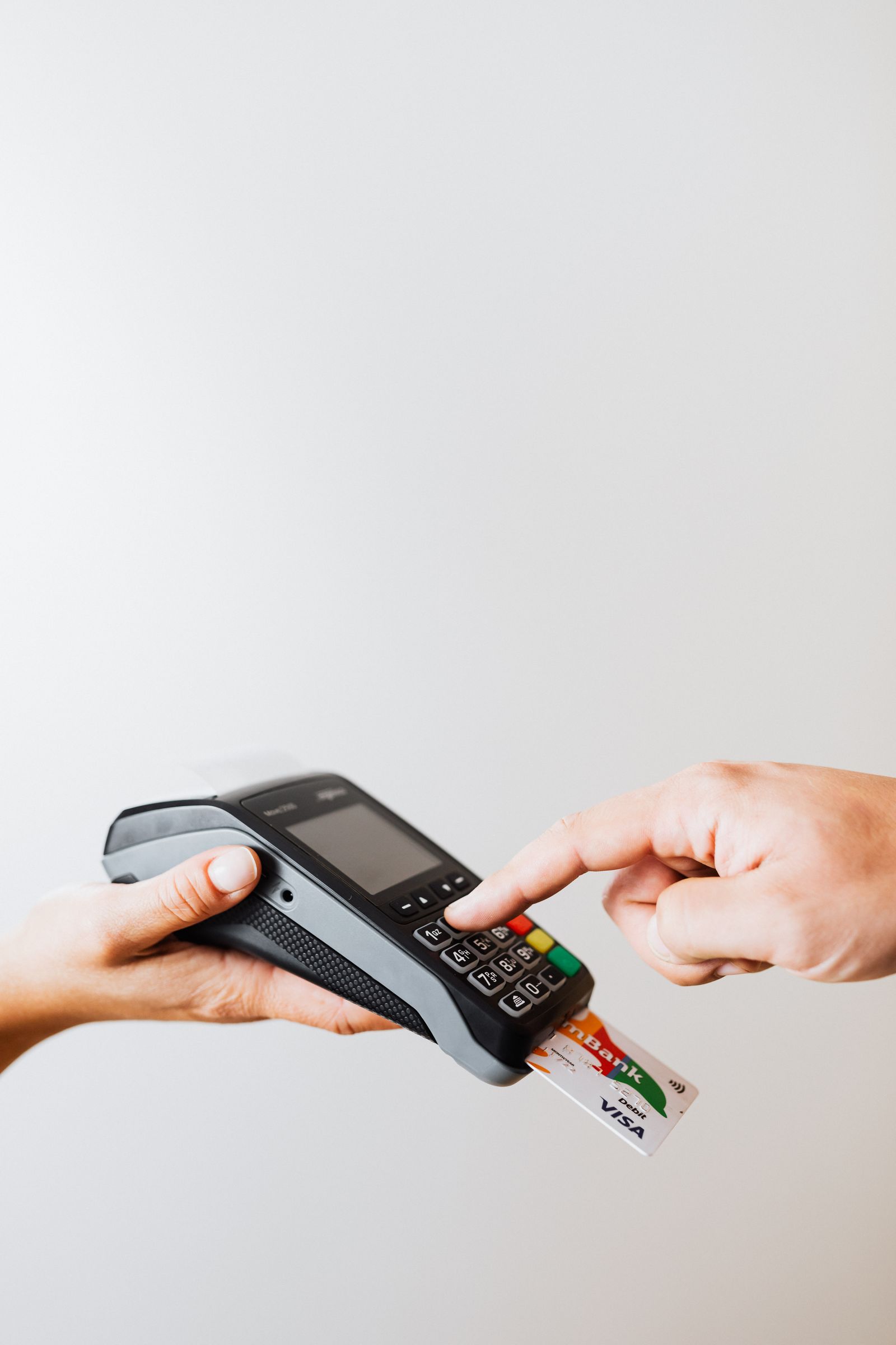 A payment card lying next to paper receipts on a table