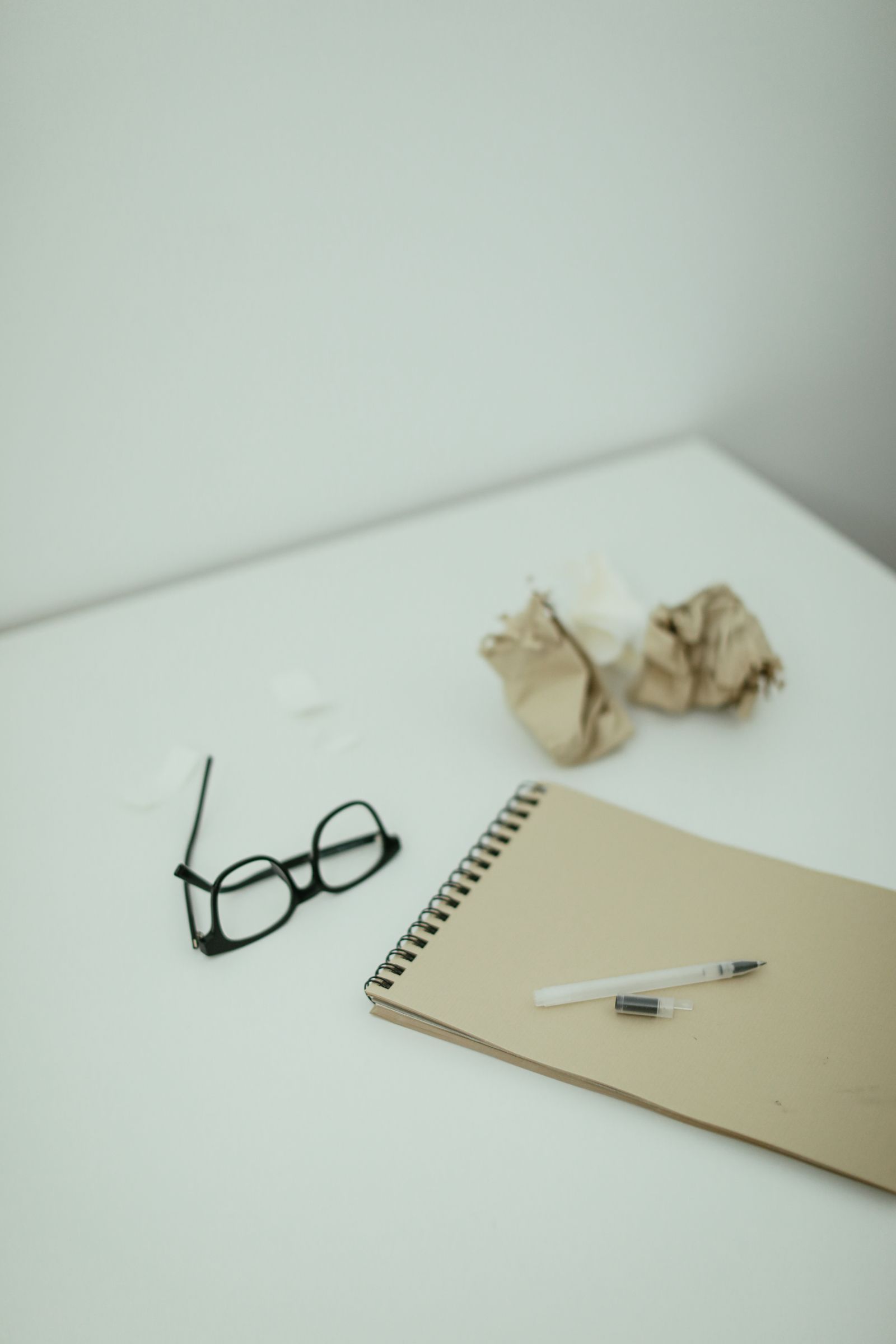 An open notebook and pen on a desk