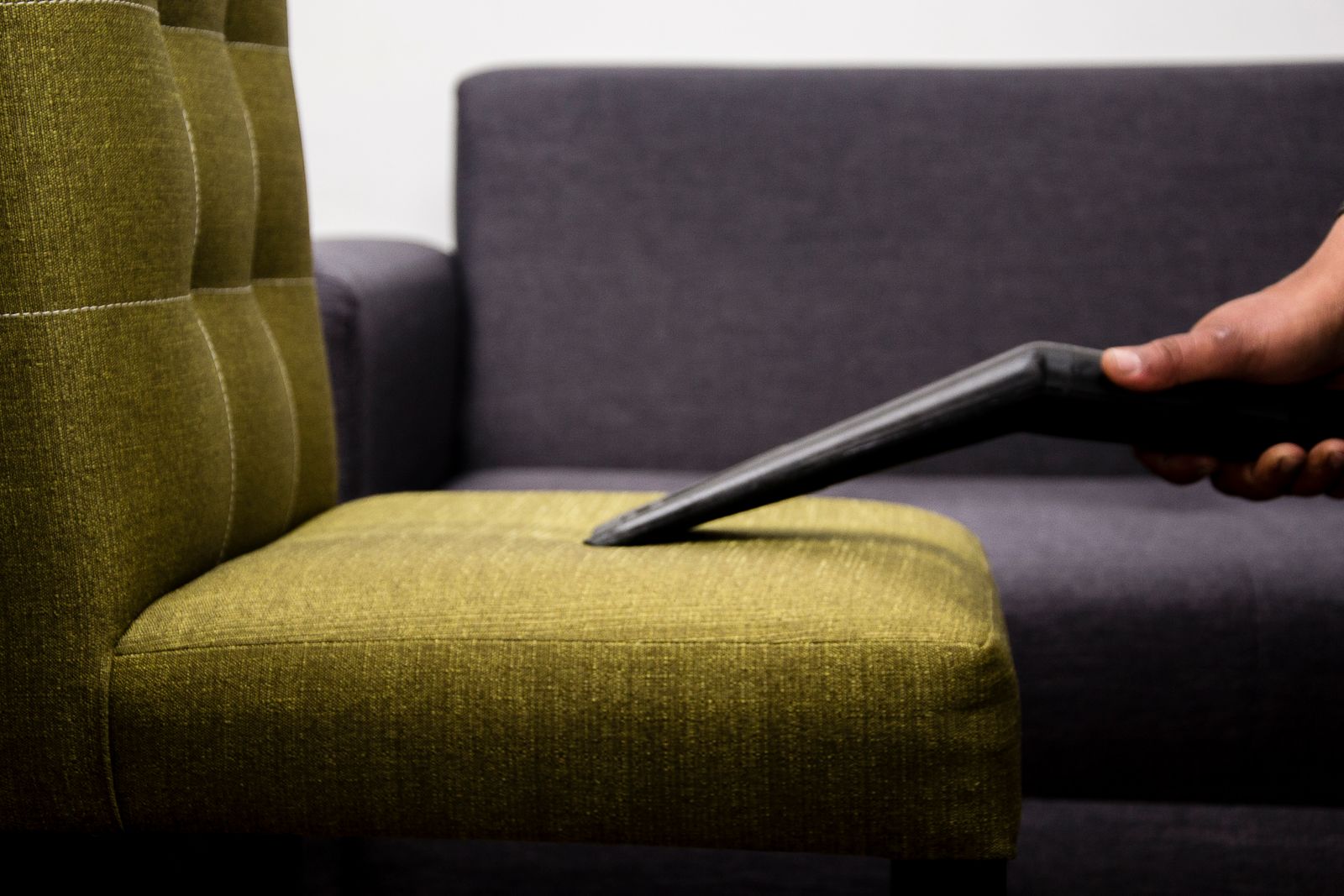 A used armchair standing in an empty room